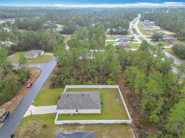 birds eye view of property featuring a view of trees