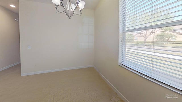 unfurnished dining area featuring recessed lighting, baseboards, and a chandelier