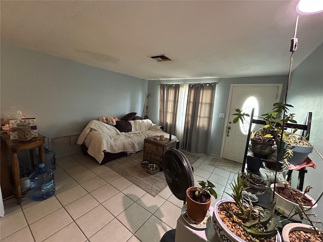 bedroom with light tile patterned floors and visible vents