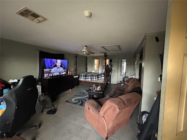 living room featuring visible vents, attic access, ceiling fan, and tile patterned flooring