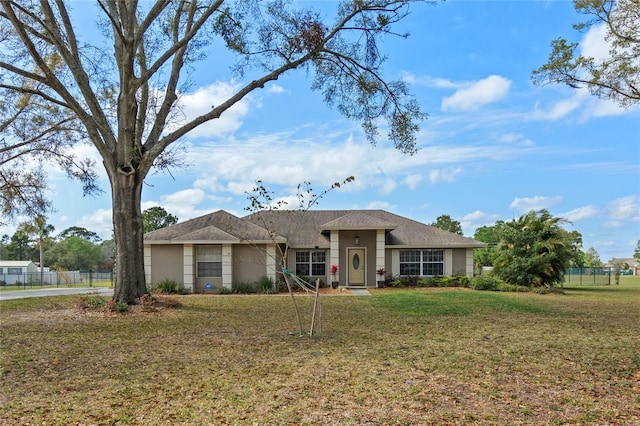 single story home featuring a front lawn and fence