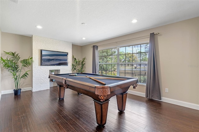 playroom with baseboards, a textured ceiling, wood finished floors, and pool table