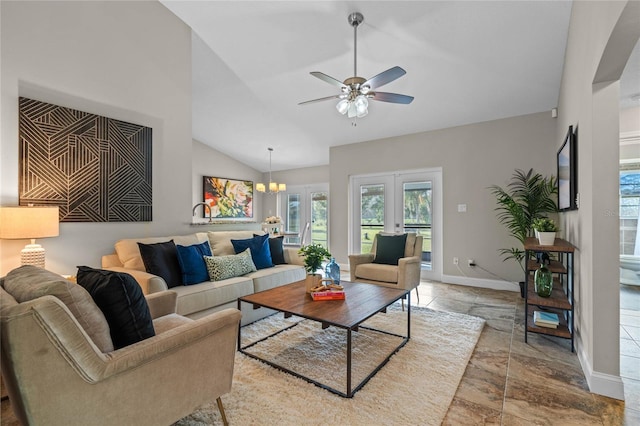 living room featuring french doors, baseboards, lofted ceiling, and ceiling fan with notable chandelier