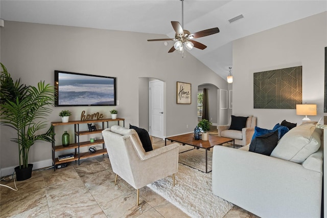 living area with visible vents, high vaulted ceiling, arched walkways, baseboards, and ceiling fan