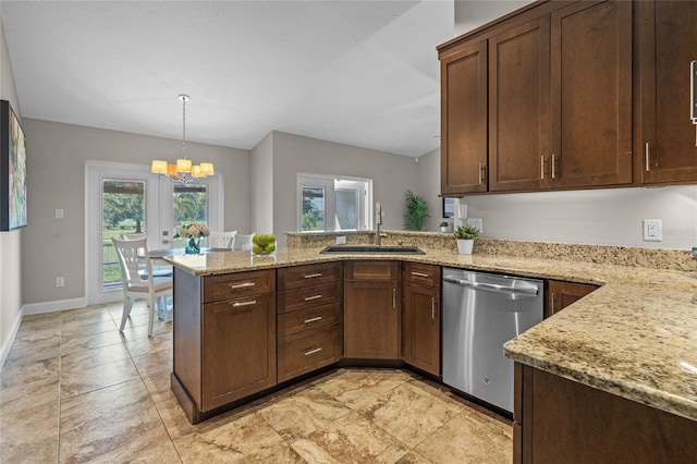 kitchen with light stone counters, a peninsula, stainless steel dishwasher, an inviting chandelier, and a sink