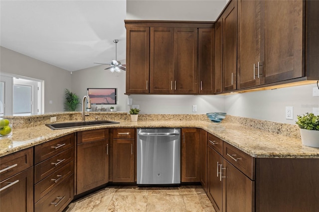 kitchen featuring a sink, light stone counters, lofted ceiling, and dishwasher