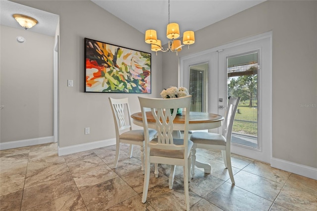 dining space featuring a chandelier, baseboards, and lofted ceiling