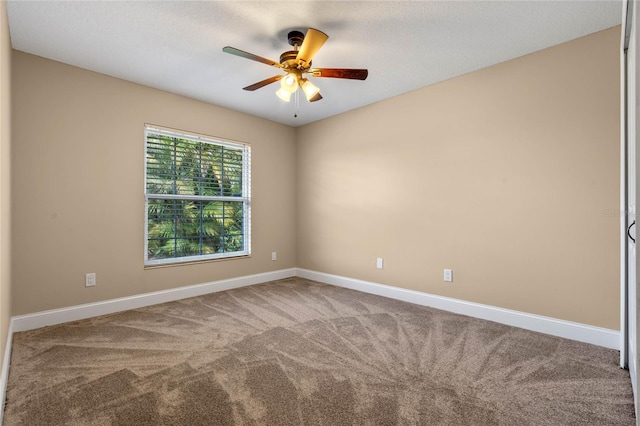 unfurnished room featuring a ceiling fan, baseboards, and carpet floors