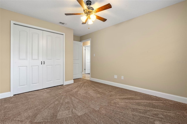 unfurnished bedroom featuring a closet, baseboards, visible vents, and carpet floors