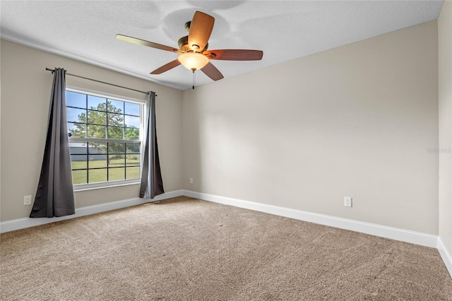 empty room featuring ceiling fan, carpet flooring, baseboards, and a textured ceiling