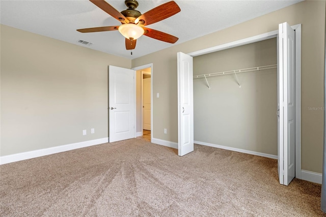 unfurnished bedroom featuring visible vents, a ceiling fan, a closet, carpet, and baseboards