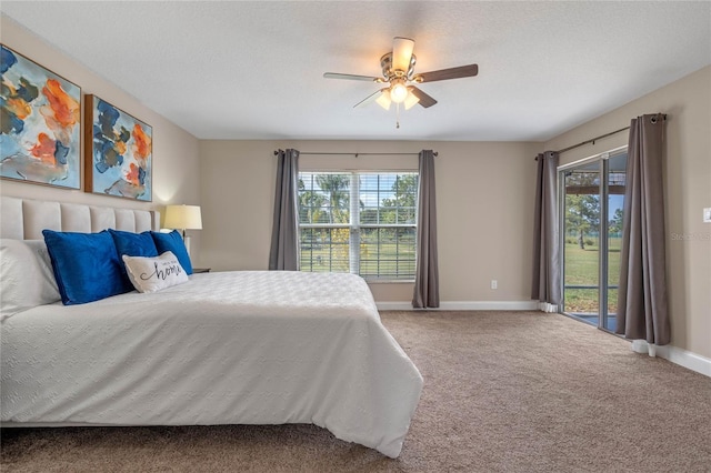 carpeted bedroom featuring ceiling fan, baseboards, a textured ceiling, and access to exterior