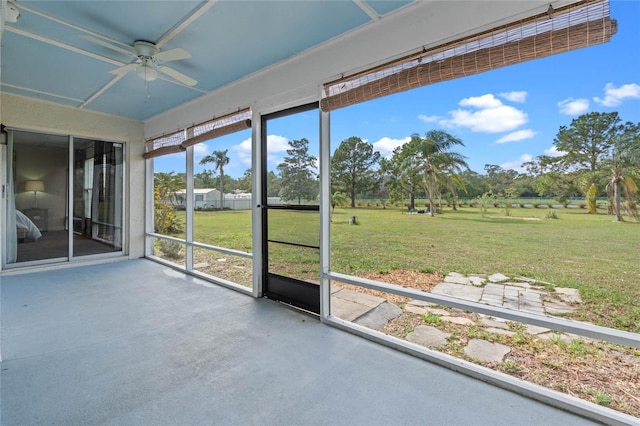 unfurnished sunroom with a ceiling fan