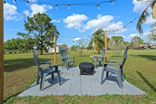 view of property's community with a patio area and a lawn