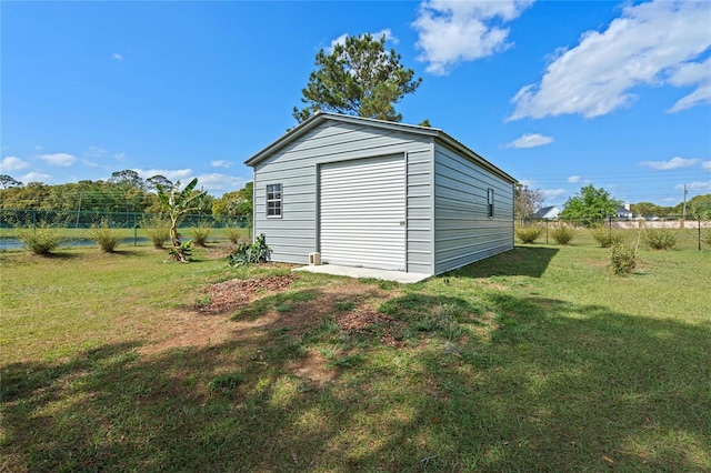 view of outdoor structure featuring an outbuilding and fence