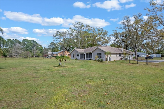 view of yard with a sunroom and fence