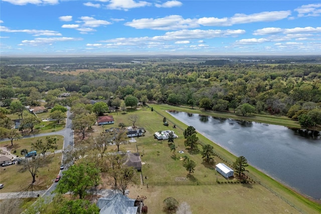 aerial view featuring a forest view and a water view