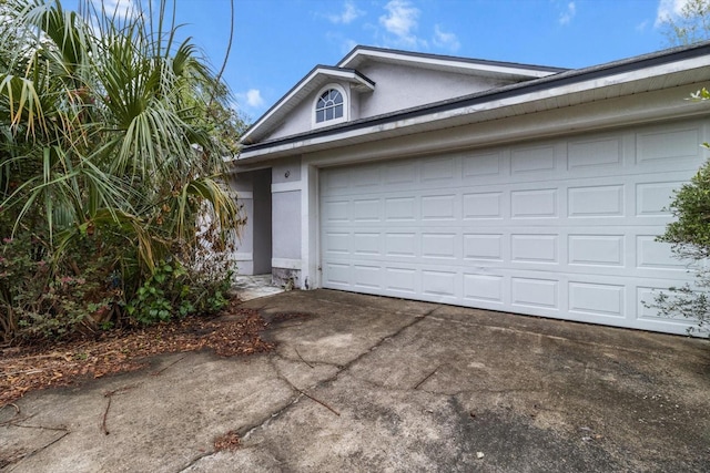 garage with concrete driveway