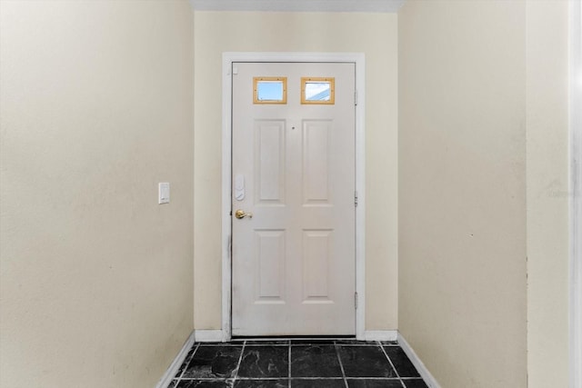 doorway featuring baseboards