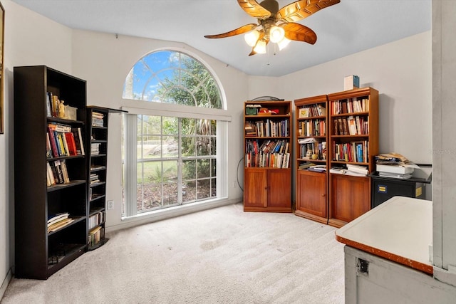 office space featuring light colored carpet, a ceiling fan, and vaulted ceiling