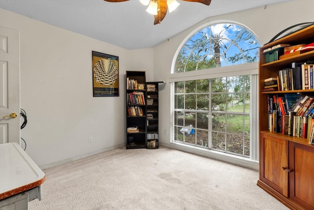 carpeted home office with baseboards, a ceiling fan, and vaulted ceiling