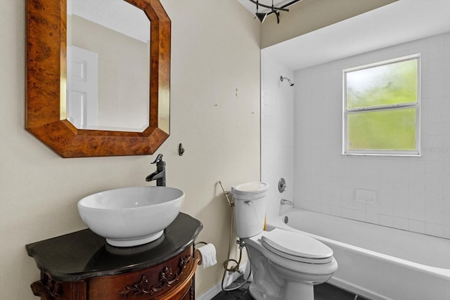 bathroom with toilet, vanity, and shower / tub combination