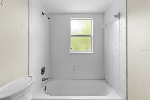 bathroom featuring toilet and shower / bathtub combination