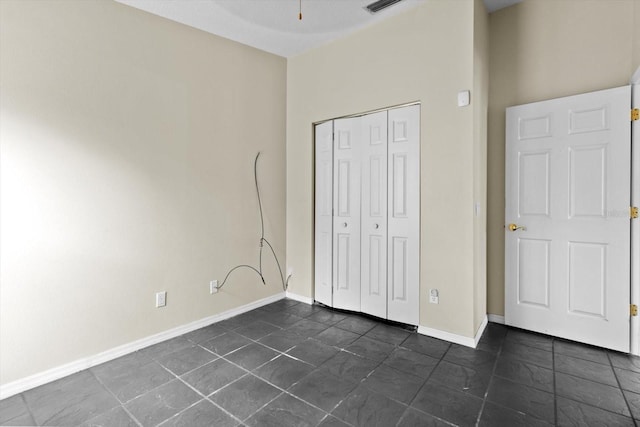 unfurnished bedroom featuring a closet and baseboards