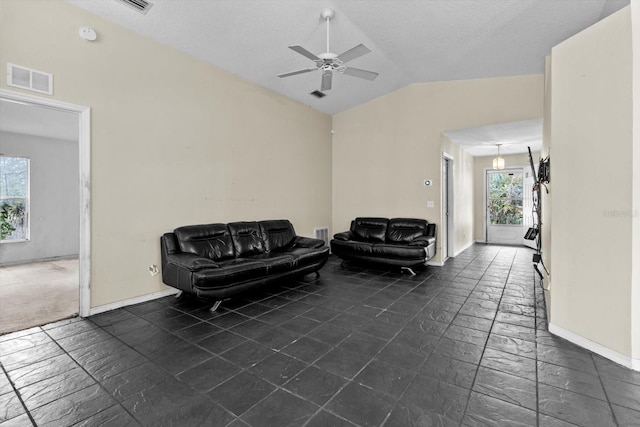 interior space featuring visible vents, lofted ceiling, baseboards, and ceiling fan