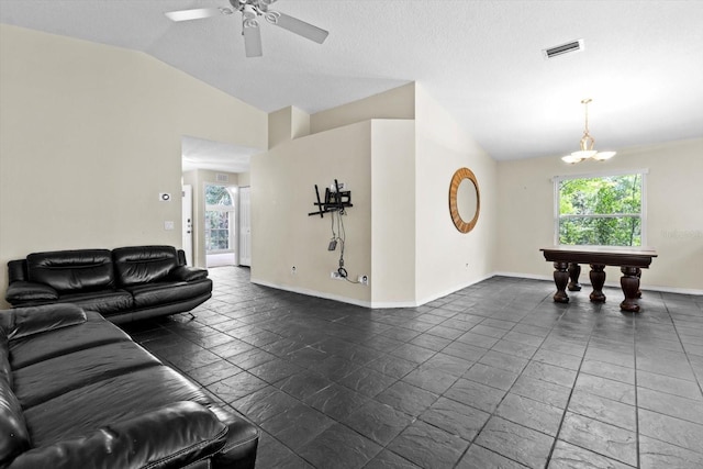 living area with vaulted ceiling, baseboards, visible vents, and ceiling fan