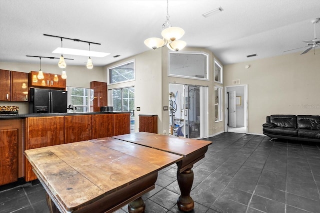 dining space featuring rail lighting, visible vents, lofted ceiling, and a ceiling fan