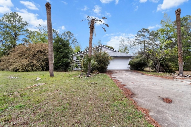 view of front facade with an attached garage, concrete driveway, and a front yard