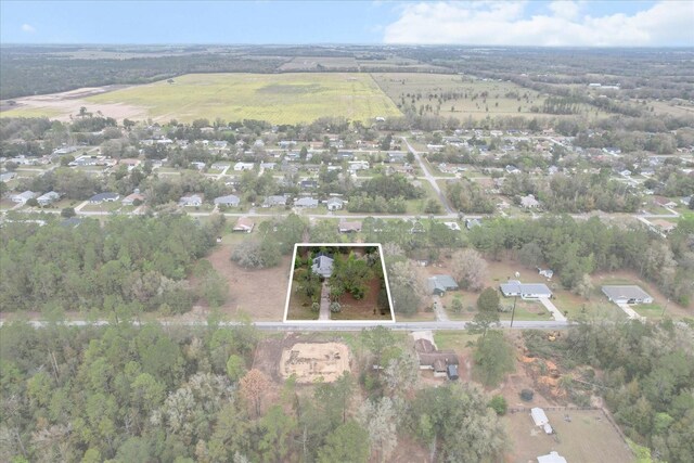 birds eye view of property featuring a rural view