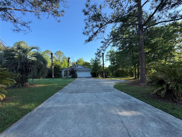 21311 SW Marine Blvd, Dunnellon, FL 34431 - view of front of property with concrete driveway and a front lawn