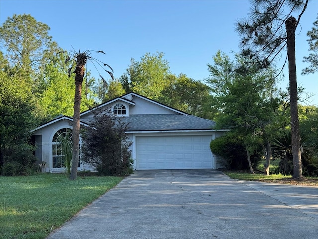21311 SW Marine Blvd, Dunnellon, FL 34431 - view of front of house featuring an attached garage, driveway, and stucco siding
