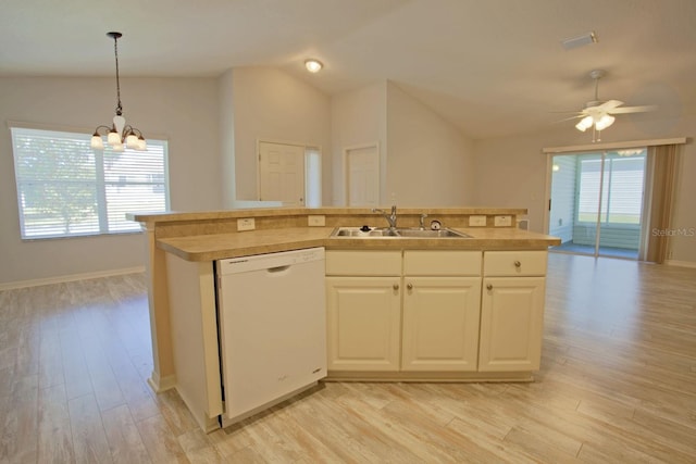 kitchen featuring vaulted ceiling, dishwasher, light wood-type flooring, and a sink