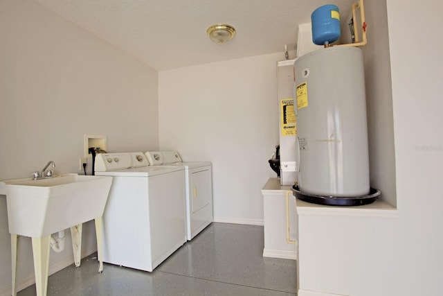 laundry area with baseboards, laundry area, a textured ceiling, washer and dryer, and electric water heater