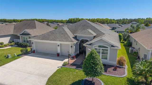 6083 Delphina Loop, The Villages, FL 32163 - view of front of property with stucco siding, an attached garage, concrete driveway, and roof with shingles