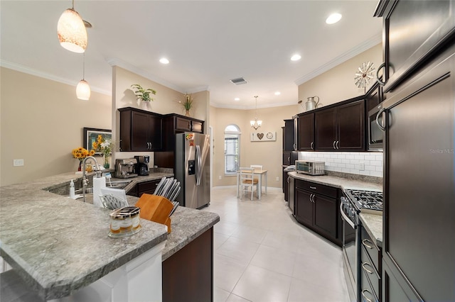 6083 Delphina Loop, The Villages, FL 32163 - kitchen featuring pendant lighting, stainless steel appliances, backsplash, and dark brown cabinetry
