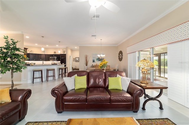 6083 Delphina Loop, The Villages, FL 32163 - living room with light tile patterned floors, visible vents, crown molding, and ceiling fan with notable chandelier