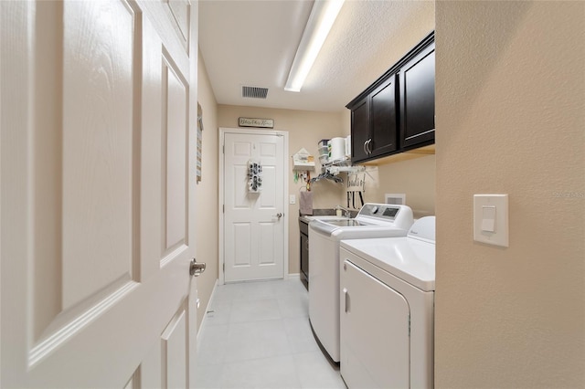 6083 Delphina Loop, The Villages, FL 32163 - clothes washing area with light tile patterned floors, visible vents, cabinet space, and washer and dryer