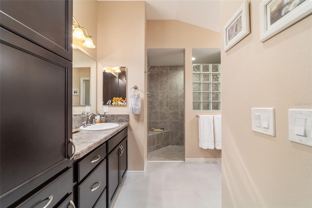 6083 Delphina Loop, The Villages, FL 32163 - full bath featuring tile patterned floors, baseboards, walk in shower, vanity, and vaulted ceiling
