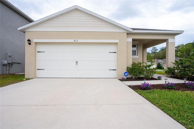 ranch-style house featuring stucco siding, an attached garage, and concrete driveway