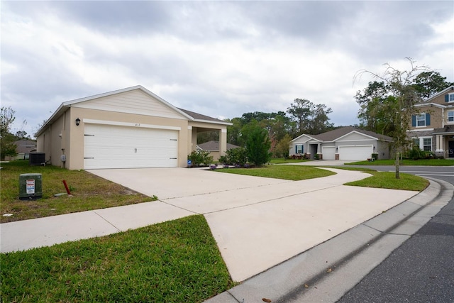 view of front of property featuring central air condition unit, stucco siding, concrete driveway, a front yard, and a garage