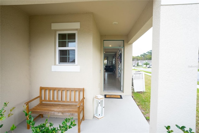 view of exterior entry featuring stucco siding