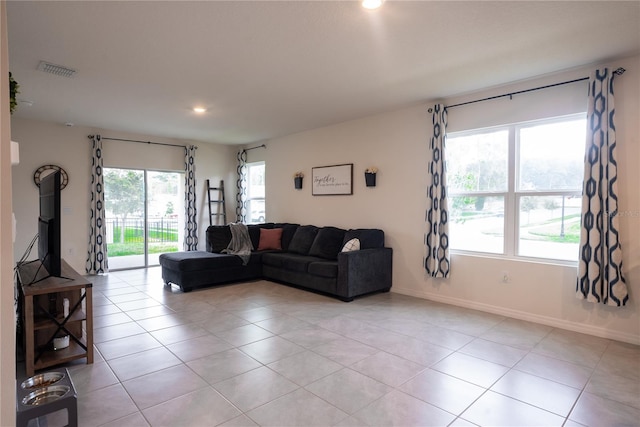 living area with recessed lighting, light tile patterned floors, baseboards, and visible vents