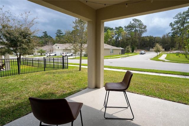 view of patio / terrace with a residential view and fence