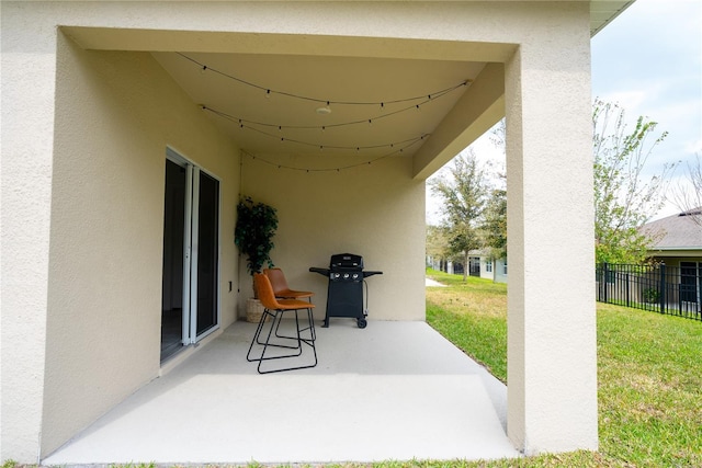 view of patio featuring grilling area and fence