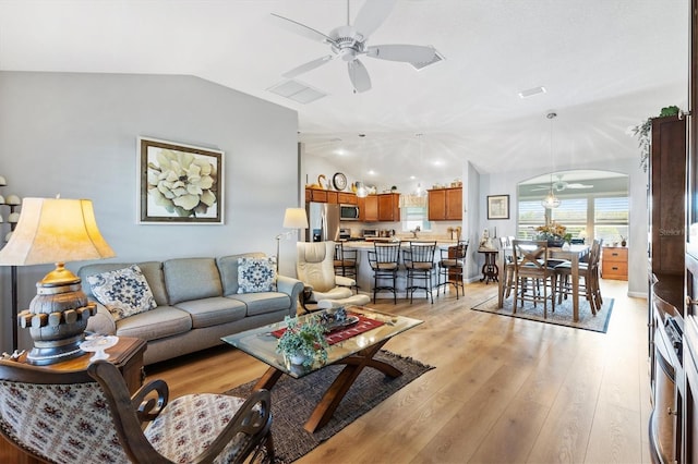 2188 Gordon Path, The Villages, FL 32163 - living room with lofted ceiling, light wood-style flooring, and a ceiling fan
