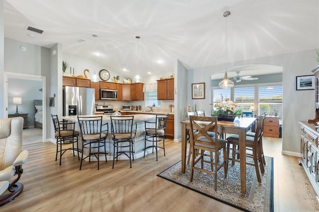 2188 Gordon Path, The Villages, FL 32163 - dining room with light wood-type flooring, visible vents, a ceiling fan, arched walkways, and vaulted ceiling